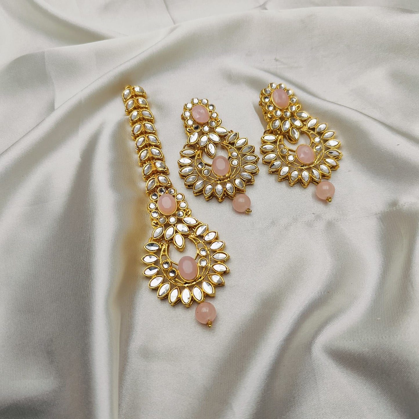 Light weight earrings and teeka set with sheesha stones and pearl drops.