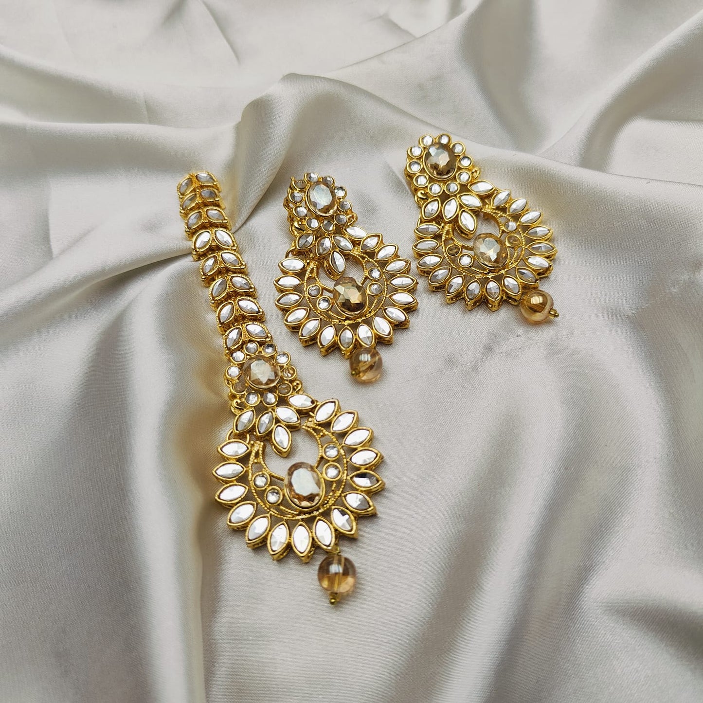 Light weight earrings and teeka set with sheesha stones and pearl drops.