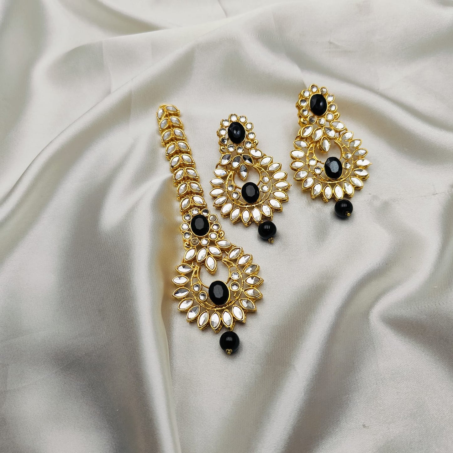 Light weight earrings and teeka set with sheesha stones and pearl drops.