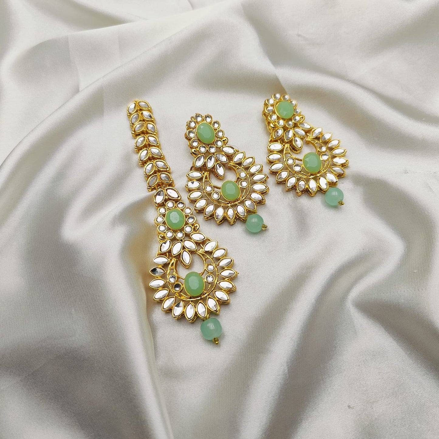 Light weight earrings and teeka set with sheesha stones and pearl drops.