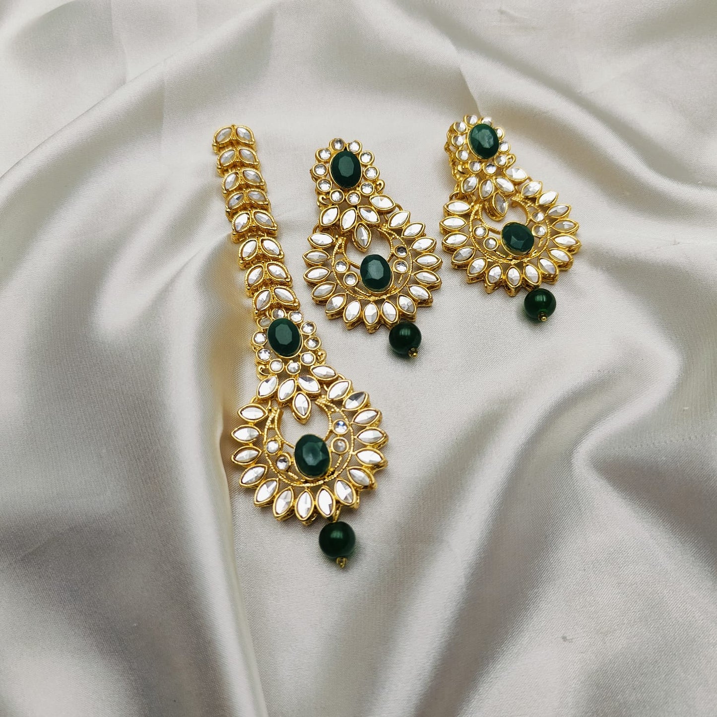 Light weight earrings and teeka set with sheesha stones and pearl drops.