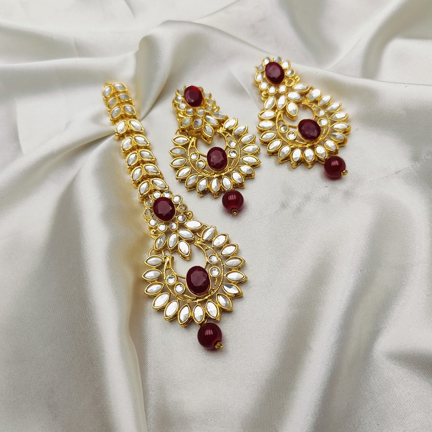 Light weight earrings and teeka set with sheesha stones and pearl drops.